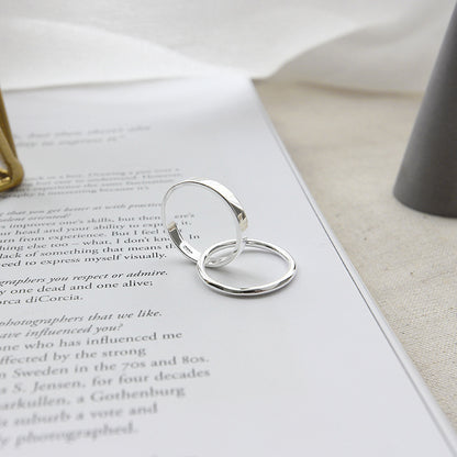 Stacked 925 sterling silver rings in minimal loop design featured in minimalist jewelry wholesale set of 5