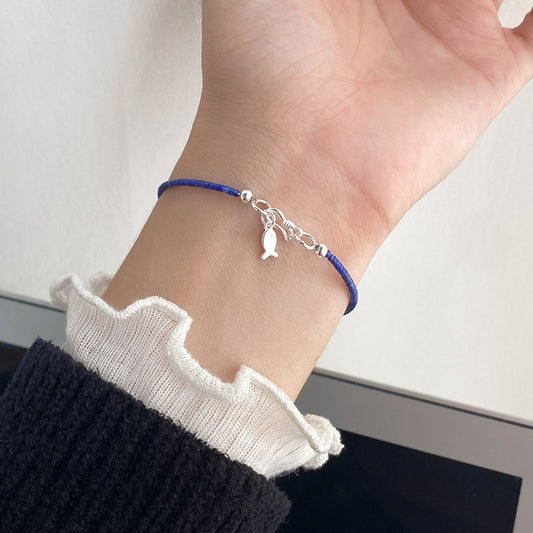 Model wearing wholesale 925 sterling silver lapis lazuli fish bracelet for everyday jewelry and bulk orders