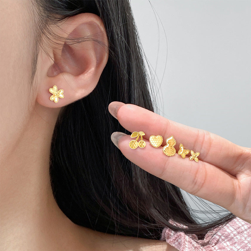 Model wearing wholesale 925 sterling silver stud earrings in assorted laser cut designs, perfect for boutique jewelry wholesale.