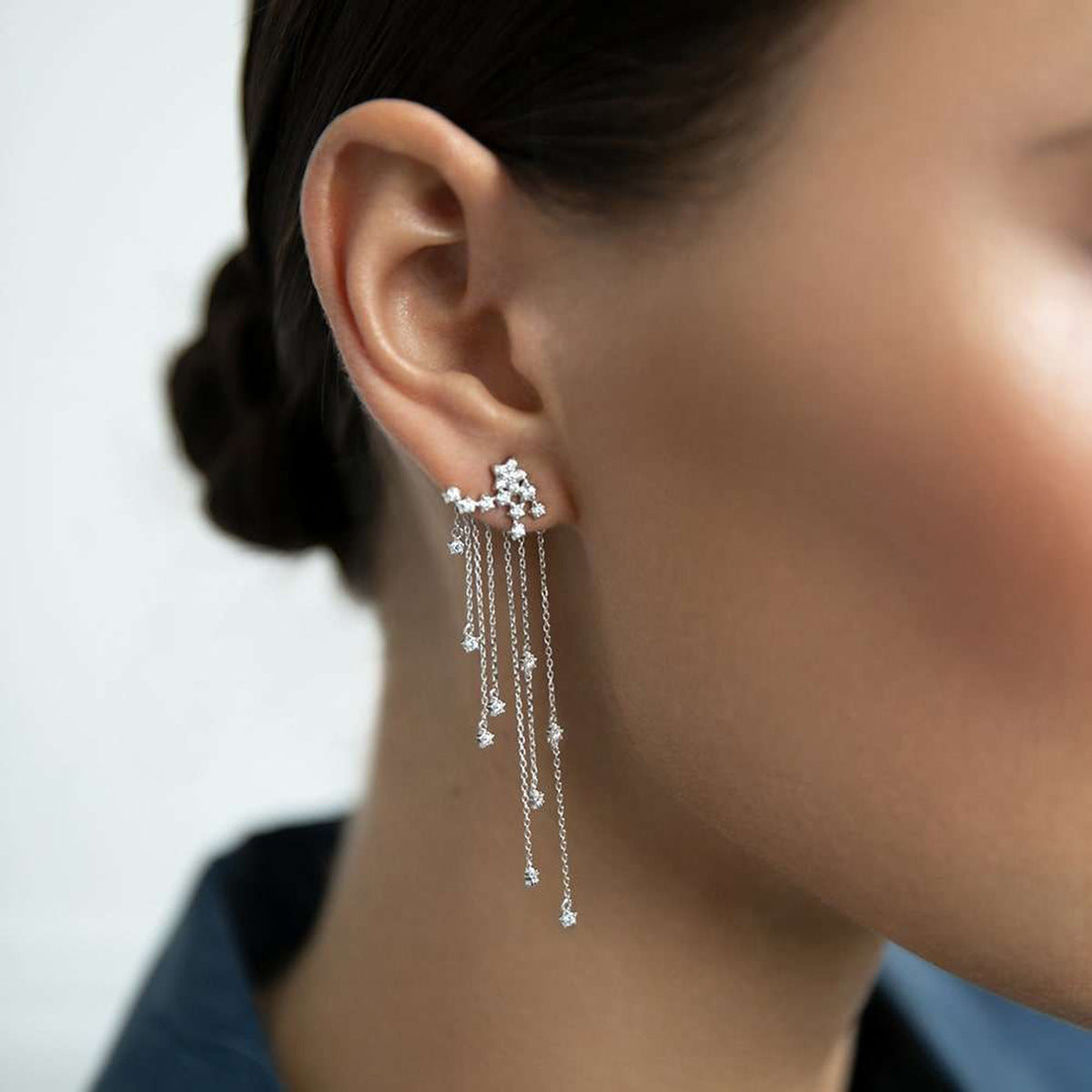 Close-up model wearing 925 sterling silver earrings wholesale, featuring cubic zirconia star tassel drop design with long chains for women, perfect for fashion jewelry wholesale suppliers.