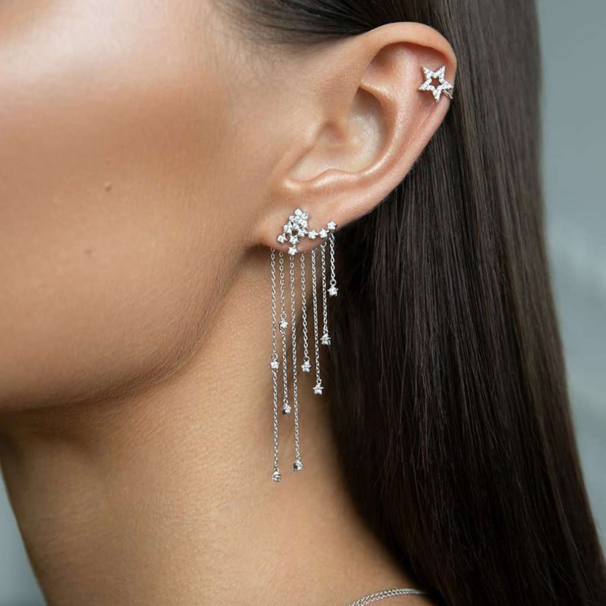 Side view of model wearing wholesale 925 silver earrings with star cubic zirconia tassels, perfect for 925 sterling silver earrings wholesale collections.