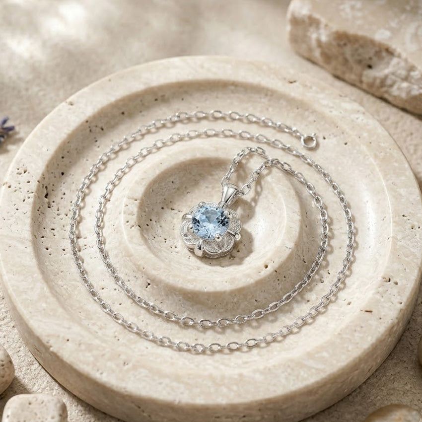 Close up of 925 silver flower pendant necklace with light blue zircon centerpiece