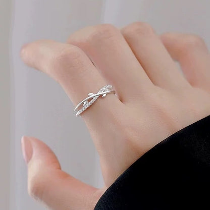 S925 sterling silver leaf open ring worn on hand with crossed branch design
