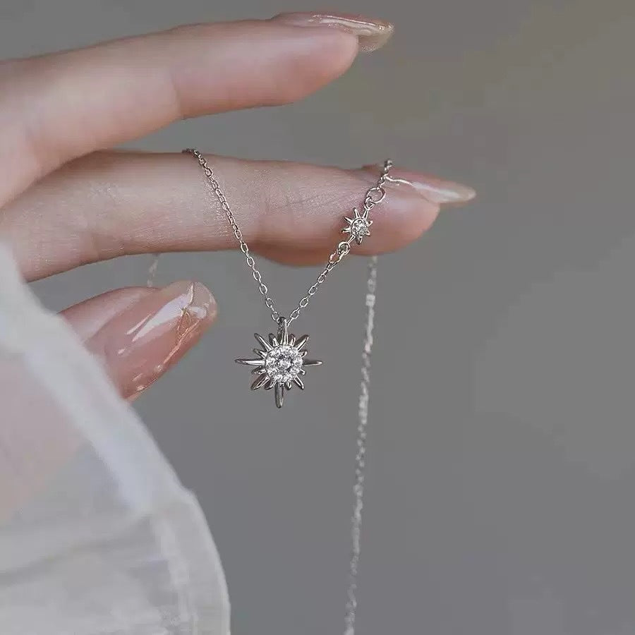 925 silver sunburst zircon pendant necklace held by hand