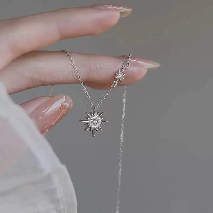 925 silver sunburst zircon pendant necklace held by hand