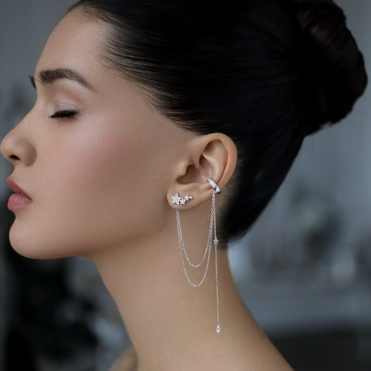 Elegant model showcasing 925 sterling silver cubic zirconia star tassel chain ear cuff, perfect for fashion jewelry wholesale suppliers.