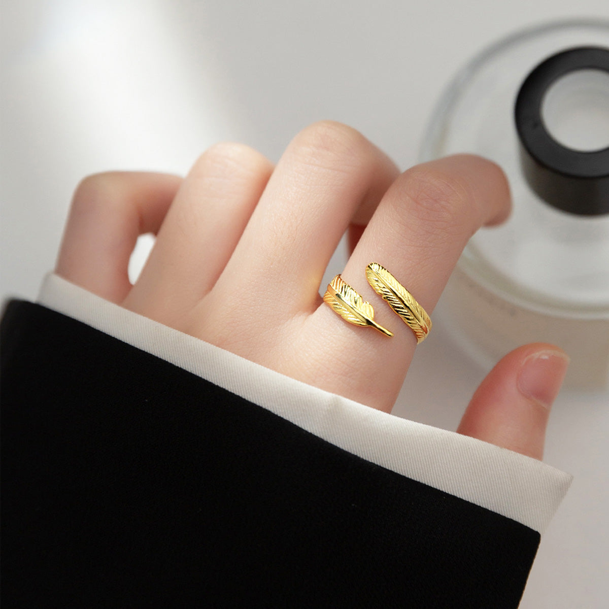 a women wearing a gold Adjustable Feather Rings