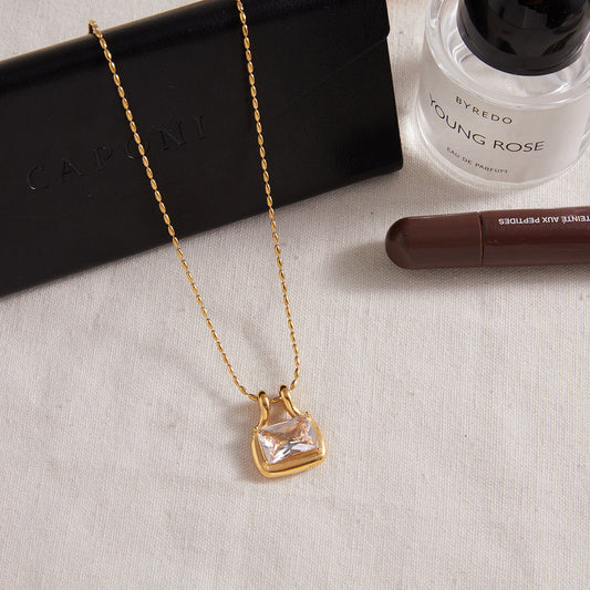 18k gold plated titanium steel zircon pendant necklace flat lay with square cut stone
