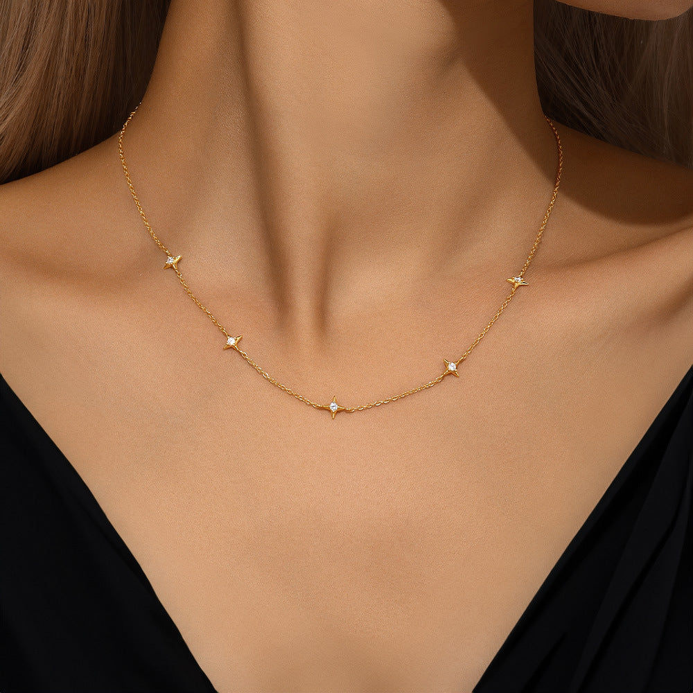 Gold S925 sterling silver station necklace with four pointed zircon stars on a model.
