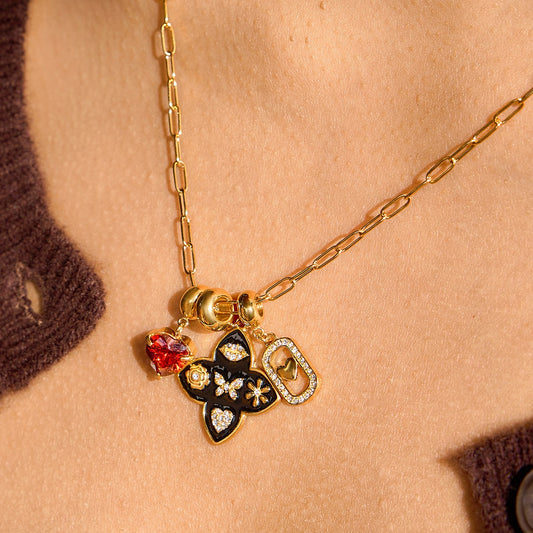 old heart charm necklace on model with red heart crystal black floral clover charm and pavé link heart charm