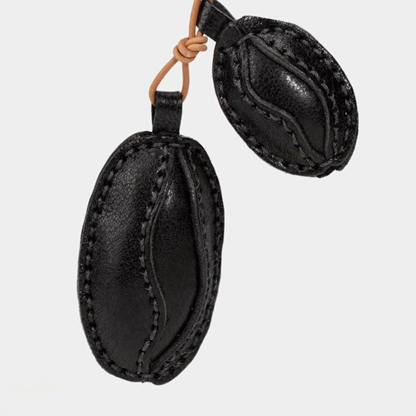 Black handmade leather coffee bean charm with stitched detail