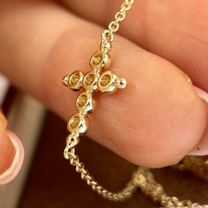 Close up of S925 sterling silver cross bracelet featuring bubble design cubic zirconia stones on wrist