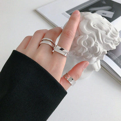 Multiple 925 silver minimalist rings stacked on hand in Korean ring style, perfect for kpop style rings and minimalist jewellery wholesale fashion boutiques.
