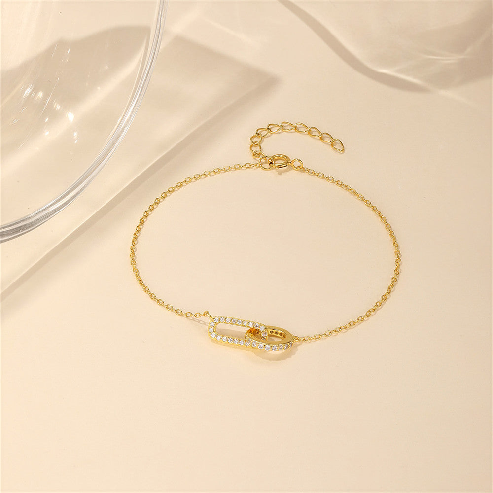 Gold plated S925 silver crossed loop bracelet with zircon pave for gift shops.

