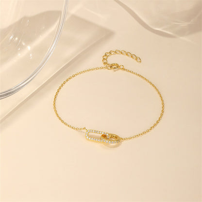 Gold plated S925 silver crossed loop bracelet with zircon pave for gift shops.
