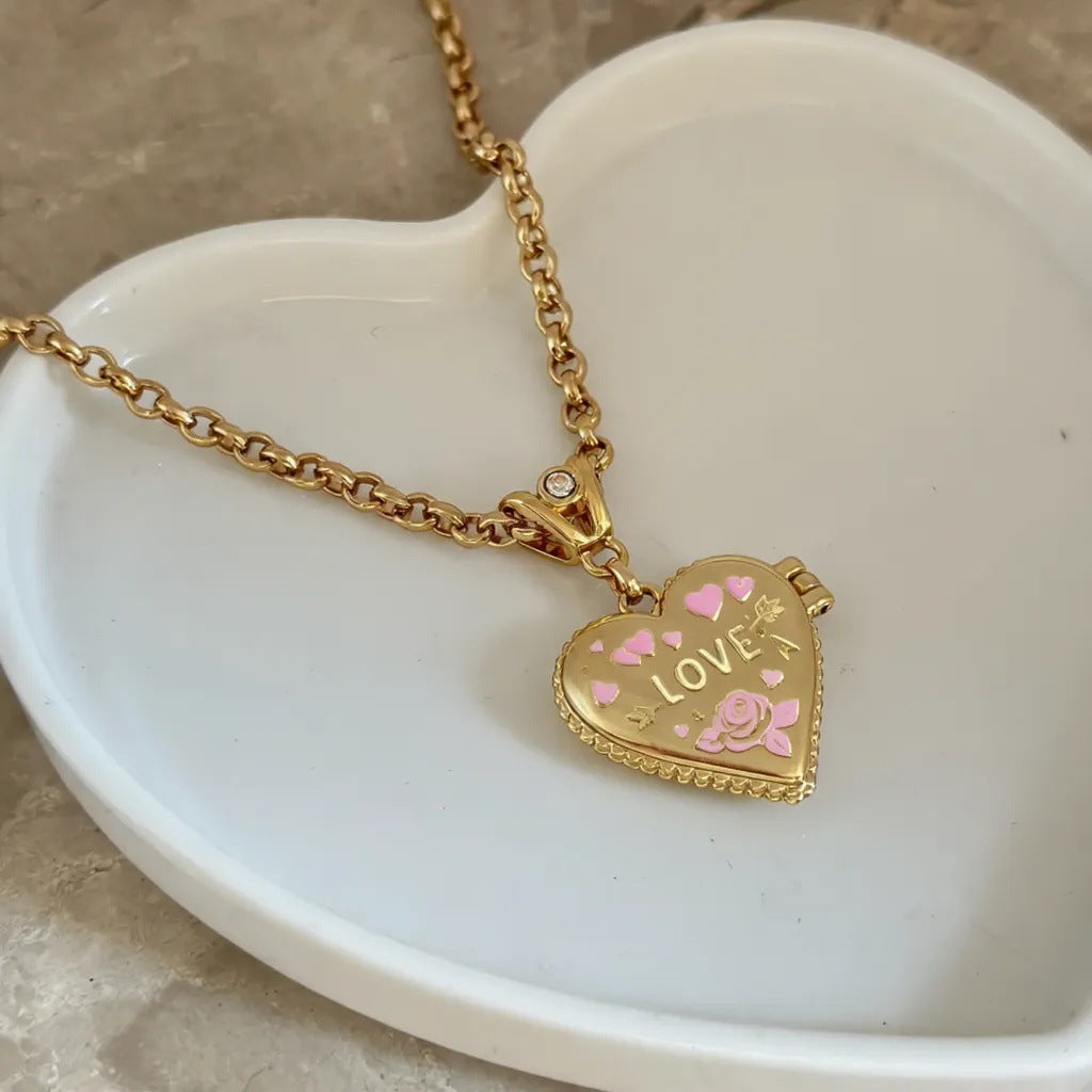 Heart locket necklace product photo on heart shaped dish with pink enamel love and rose details