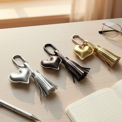 Assorted leather heart keychains with tassels in silver, gold, and bronze, perfect for bulk gifts.