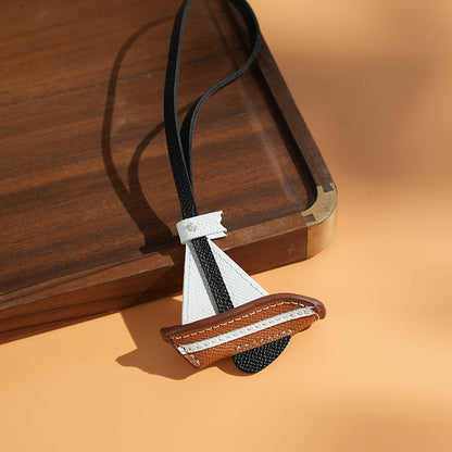 Size reference of leather sailboat charm with black strap