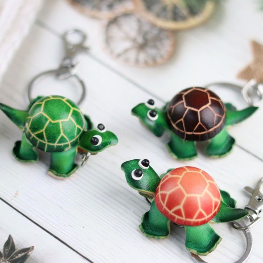 Set of mini turtle leather keychains in green brown and orange shells