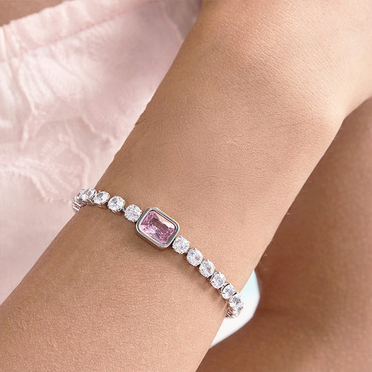 A dazzling stainless steel CZ tennis bracelet with a central pink cubic zirconia gem, offering a minimalist take on pink tennis bracelets and ideal for gift sets or valentines jewelry for her.