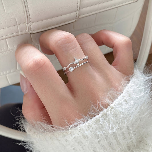 Adjustable celestial stacking ring crafted from sterling silver with star motif