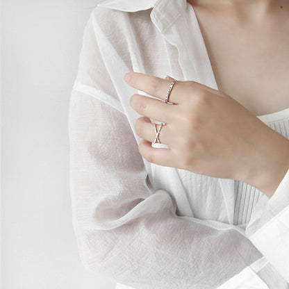 Double band sterling silver rings with crossover design worn by model in white blouse - best-selling kpop style rings for wholesale jewelry buyers
