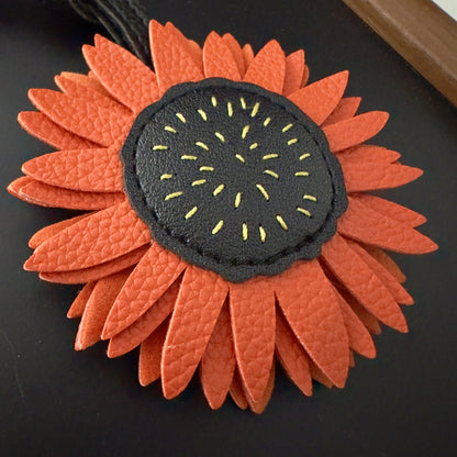 Close up of PU leather sunflower bag charm wholesale accessory showing texture and stitching for Christmas gift ideas for women and cute small gifts for Christmas