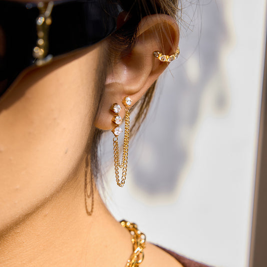 Side view of the layered chain earrings with white zircon studs on a model for fashion inspiration.
