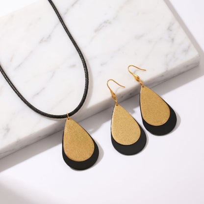 lack gold stainless steel necklace and earring set with teardrop pendant and matching drop earrings
