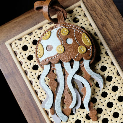 Sheepskin Leather Jellyfish Bag Charm Wholesale PU Leather Keychain Accessories displayed on canvas handbag as cute jellyfish keychain