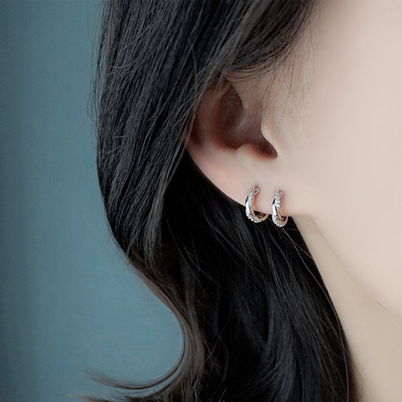 a woman wearing 925 Sterling Silver Curved Crystal Earrings