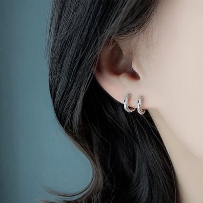 a woman wearing 925 Sterling Silver Curved Crystal Earrings