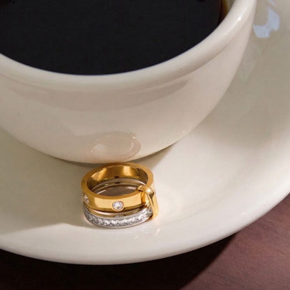 Wholesale two tone stainless steel ring displayed beside cup