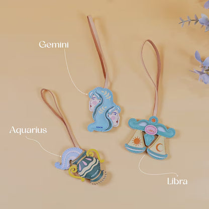 Zodiac bag charm wholesale handmade leather keychain accessories featuring Taurus Capricorn and Virgo signs displayed on handbag
