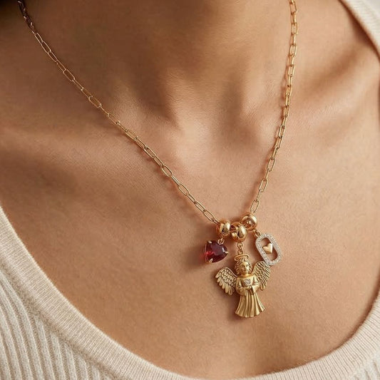 Model wearing gold tone charm necklace with angel charm heart crystal and heart lock pendant