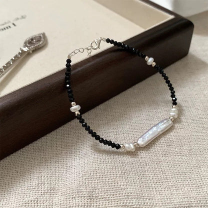 S925 bracelet with black spinel beads and an elongated freshwater baroque pearl centerpiece