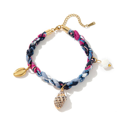 Blue braided ocean bracelet with shell charm and cowrie style pendant gold plated