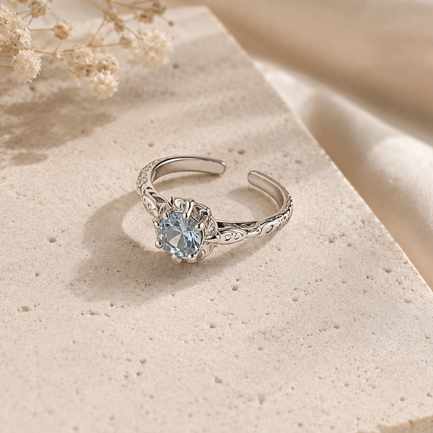 925 sterling silver adjustable ring featuring round blue zircon stone and floral detailing