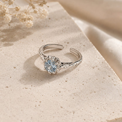 925 sterling silver adjustable ring featuring round blue zircon stone and floral detailing
