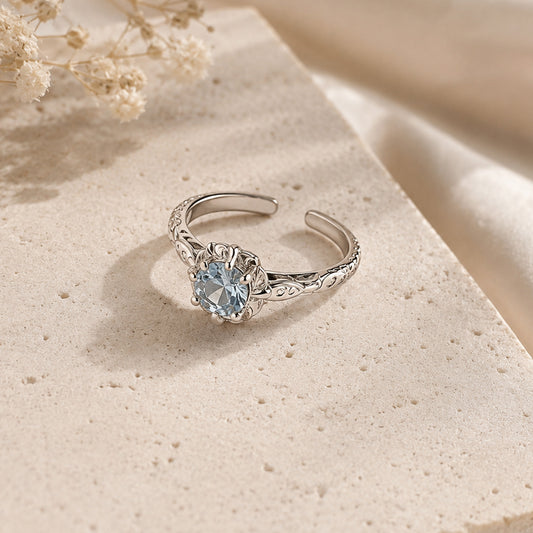 925 sterling silver adjustable ring featuring round blue zircon stone and floral detailing