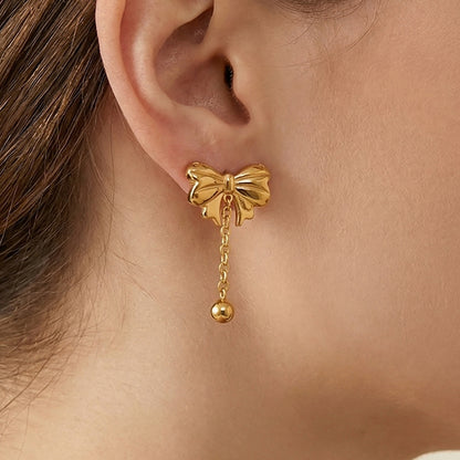 Bow drop earring close up gold tone stainless steel bow tassel stud earring