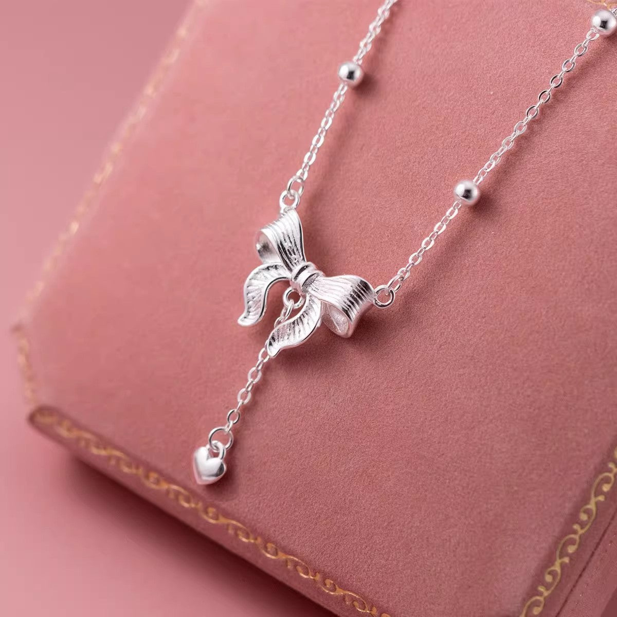 S925-Sterling-Silver-Bow-Necklace-with-Heart-Pendant-on-Pink-Jewelry-Box
