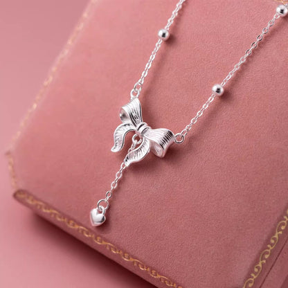 S925-Sterling-Silver-Bow-Necklace-with-Heart-Pendant-on-Pink-Jewelry-Box