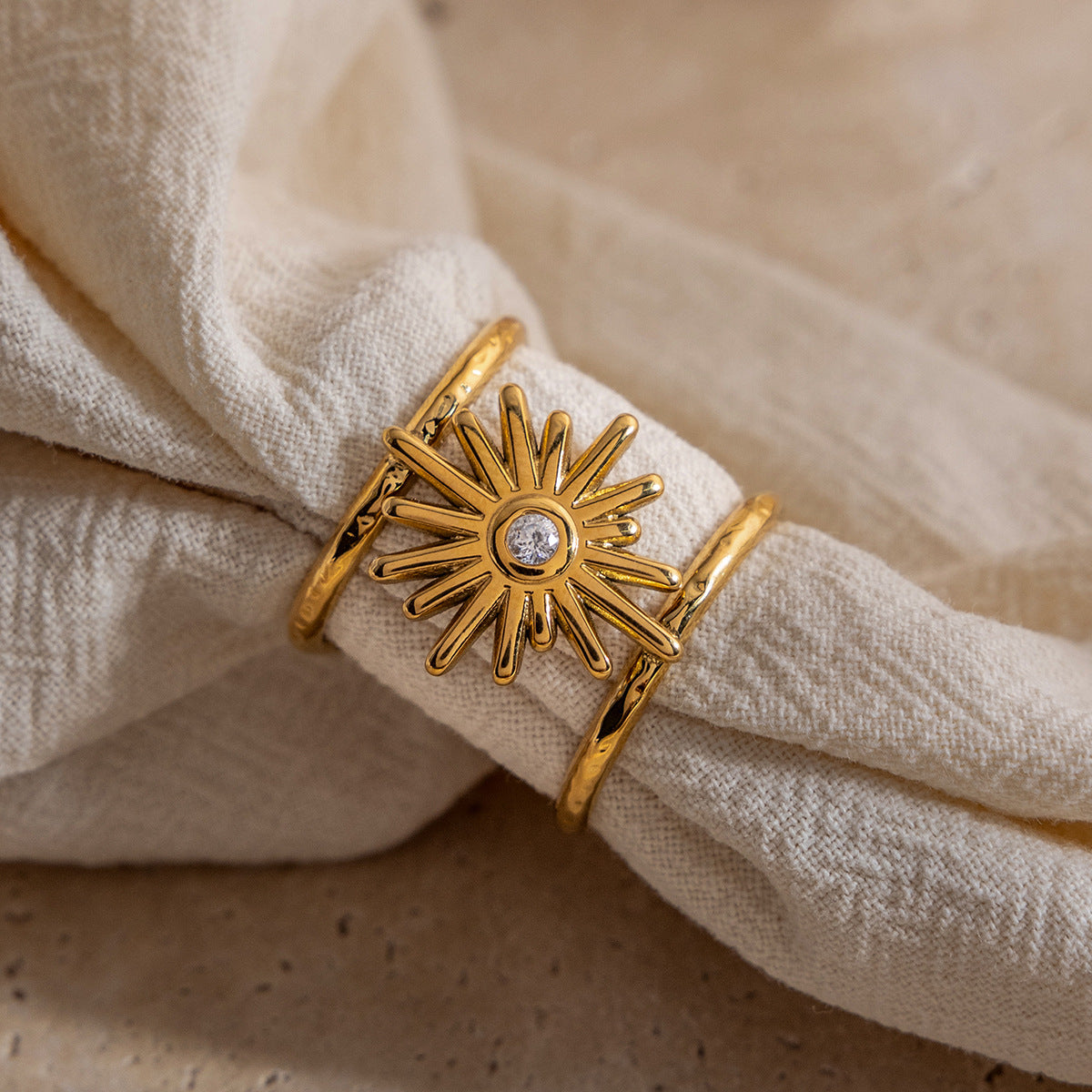 Celestial jewelry wholesale: set of gold and silver alloy rings including sun-swirl, sunburst, and crescent moon designs.