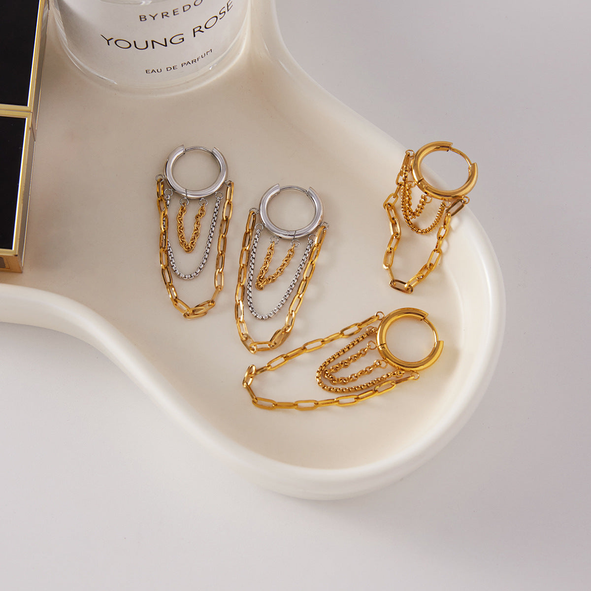 Assorted gold and mixed metal chain tassel hoop earrings for wholesale display