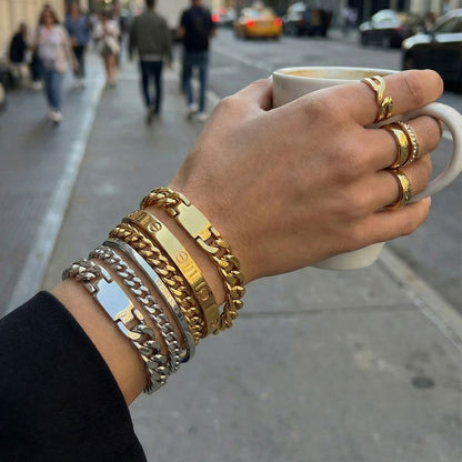 Gold tone chunky cuban link bracelet U clasp on fabric flat lay