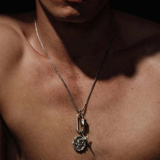 Model wearing stainless steel carabiner pendant necklace with coin portrait pendant and sword charm