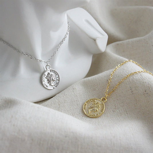Gold and silver 925 sterling vintage coin pendant necklaces displayed on fabric wholesale 925 silver jewelry