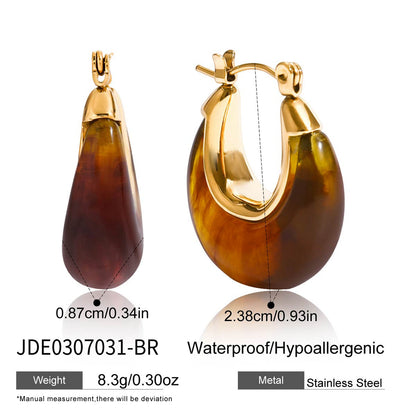 Amber brown resin hoop earrings with polished gold tone stainless steel details