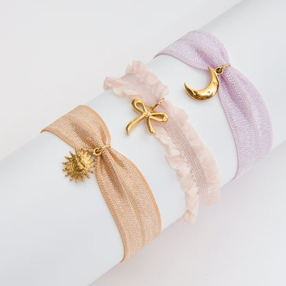 Adjustable coquette ribbon bracelets with stainless steel sun, moon, and bow charms, ideal for minimalist wholesale jewelry lines